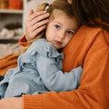 Parent comforting a child after a nightmare